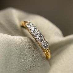 a diamond ring sitting on top of a white cloth