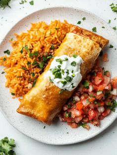 mexican food on a plate with rice, beans and sour kraut garnished with cilantro