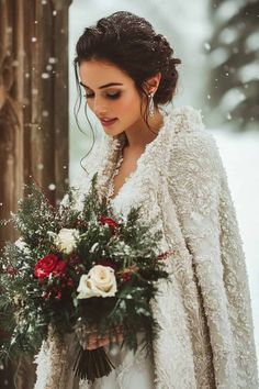 a woman holding a bouquet in the snow