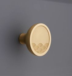 a close up of a door knob with waves on it's face and the handle is gold