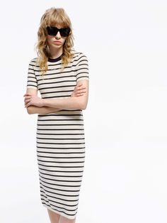 MO&Co. Women's Round Neck Striped Dress Crafted with a blend of wool and fabric, this mid-length T-shirt dress boasts a modern silhouette and stylish striped design. Perfectly pair with short boots for a minimalist, fashion-forward look. Features : - Midi T-shirt dress silhouette- Classic black and white stripes- Round neck, short sleeves Code: MBD1DRS038The back length of size S is 104cmMATERIALS & CARE Material: 67.7% Wool 32.3% PolyesterWrap metal parts before dry cleaning.REMINDER: All items Chic Fitted Dresses With Striped Hem, Spring Striped Bodycon Midi Dress, Striped Midi Dress For Work, Striped Knee-length Midi Dress For Work, Fitted Short Sleeve Dress With Vertical Stripes, Chic Striped Ribbed Midi Dress, Fitted Dress With Vertical Stripes And Short Sleeves, Chic Ribbed Striped Midi Dress, Spring Workwear Dresses With Contrast Stripes