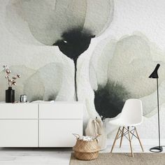 a living room with white furniture and large flower wall mural on the wall behind it