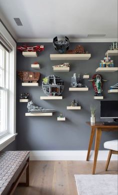 a room with some shelves on the wall and a desk in front of it,