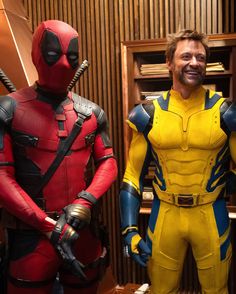 two men dressed as deadpool and wolverine in front of a bookcase with books