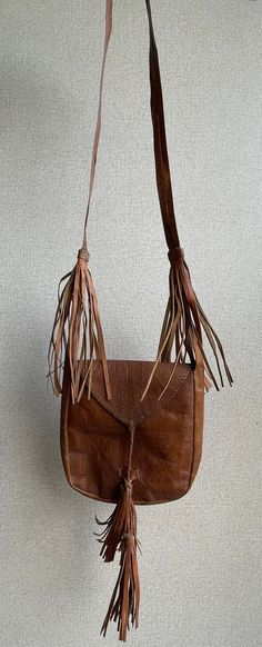 Vintage leather bag African vintage leather Full Length: 36 inches Width: 9 inches Rectangular Brown Satchel With Tassels, Vintage Leather Bags With Fringe, Brown Satchel Shoulder Bag With Tassels, Brown Shoulder Bag Satchel With Tassels, Brown Tassel Shoulder Satchel, Leather Shoulder Bag With Tassels For Travel, Leather Travel Shoulder Bag With Tassels, Leather Rectangular Bag With Tassels, Rectangular Leather Bag With Tassels