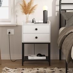 a bedroom with a bed, night stand and lamp on the nightstand next to it