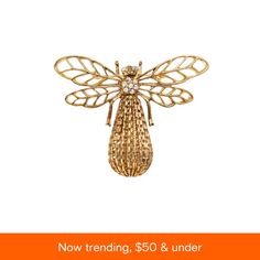 a brooch with a gold insect on it and the words now trending $ 50 & under