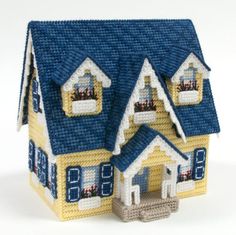 a small toy house with blue roof and windows