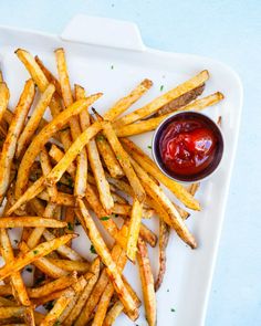 french fries with ketchup on a white plate