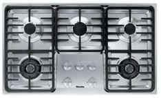 a gas stove top with four burners on it