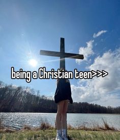 a woman standing in front of a cross with the words being a christian teen > > >