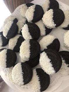 a white plate topped with black and white cookies