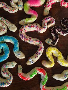 there are many decorated doughnuts on the table with sprinkles all over them