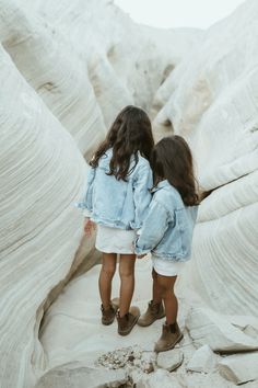 two young sisters blue denim jackets white skirts holding hands looking down white slot at amangiri resort Lifestyle Photography Family