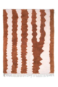 a brown and white striped rug with fringes