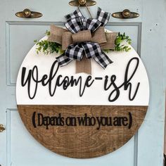 welcome - ish door hanger with plaid bow on it and words that spell out, plants on who you are