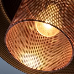 an overhead view of a light fixture with a wire mesh covering the top and bottom