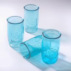 three blue glass jars sitting next to each other