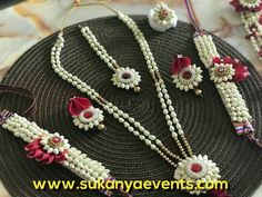 several necklaces and bracelets are arranged on a round plate with bead work