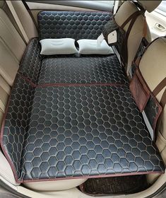 the interior of a car with an open trunk and back seat cushion on it's side