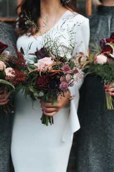 three bridesmaids holding bouquets of flowers in their hands