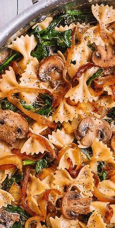 pasta with mushrooms and spinach in a pan