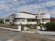 a large white house sitting on the side of a road