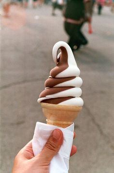 an ice cream cone with chocolate and white icing