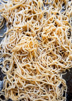 some noodles are being cooked in a pan