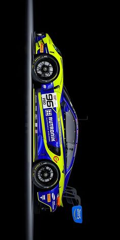 a yellow and blue race car hanging upside down