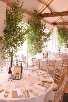 the tables are set with white linens and place settings for an elegant wedding reception