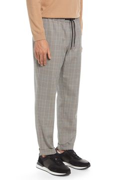 Topped with a comfy elastic waist, these versatile work-to-weekend pants feature a crisp houndstooth-plaid pattern that lends a smart, polished touch. 28 1/2" inseam; 14" leg opening; 11" front rise; 16 1/2" back rise (size Medium) Elastic/drawstring waist 70% polyester, 29% rayon, 1% spandex Machine wash, tumble dry Imported Men's Clothing