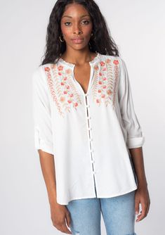 Looking for a Spring wardrobe refresh? This simple yet refined long sleeve bohemian blouse features a delicate self-covered button front, flattering split v-neckline, and floral embroidered detail. Wear it loose over denim, or try it tied in the front. Vintage floral embroidery Relaxed fit Long rolled sleeve with button tab closure Rounded hemline Side vents V-neckline Lace trim Self-covered button front Can be tied at the front Bohemian top Model is 5'9, wearing a size S.Style: I-13797W-RPX Spring Bohemian Blouse With Buttons, Bohemian Spring Blouse With Buttons, Bohemian Spring Tops With Buttons, Bohemian Blouse With Button Closure For Vacation, Spring Bohemian Button-up Tops, Bohemian Button-up Blouse For Vacation, White Henley Neckline Top For Spring, Spring Split Neck Tops With Buttons, Bohemian Tunic Top With Buttons