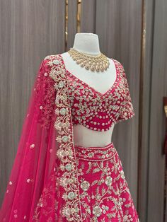 Cerise pink enhanced with pearl, diamonds stone & beads, sequence work highlighted in multi thread floral embroidery flared lehenga. Accomplished with similarly embroidered designer blouse and net dupatta. This pink lehenga is something extraordinary about the blend of ethnic fashion with contemporary details. Fabric: Raw Silk Size: 38/M Occasion: Wedding Ceremony or Reception WASH CARE INSTRUCTIONS - Please Dry clean only when it is applicable. Slight color variation is possible due to digital Pink Embellished Party Wear Lehenga, Pink Embellished Semi-stitched Choli, Designer Pink Embellished Choli, Pink Embellished Dola Silk Dupatta, Pink Embellished Organza Lehenga, Embellished Pink Dola Silk Dupatta, Pink Kundan Lehenga For Parties, Pink Embellished Party Wear Traditional Dress, Pink Embellished Traditional Party Wear