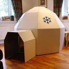 an inflatable house with snowflakes on the roof and windows behind it