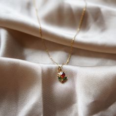 Ultra Dainty Flower Necklace Tulip Necklace Rose Necklace Flower Charm Necklace Beauty and the Beast Inspired Delicate Jewelry Minimalist ☽ 14k Gold plated charm (6.3x7.5mm), red and green cubic zirconia, PLEASE BE AWARE this is a very dainty and delicate necklace (look at pictures to view the size on the model). ☽ This charm is gold plated meaning that it will tarnish over time. PLEASE follow these tips to make the charm last longer in its original condition: avoid wearing it to the beach, pool Dainty Rose Necklace, Ornate Necklace, Dainty Jewelry Necklace, Tulip Necklace, Pretty Jewelry Necklaces, Flower Charm Necklace, Jewelry Minimalist, Necklace Flower, Small Jewelry Box