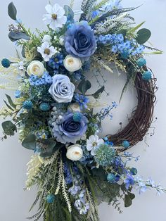 a wreath with blue flowers and greenery