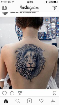 the back of a woman's shoulder with a lion tattoo on it