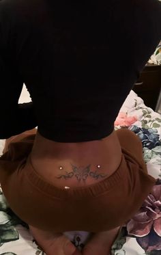 a woman with a small tattoo on her lower back and bottom part of her stomach