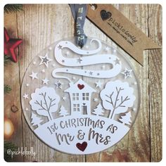 a christmas ornament hanging on a wooden wall next to a star and tree