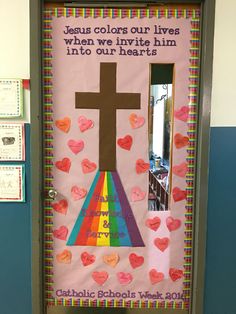 a bulletin board decorated with hearts and a cross on the front door that says jesus colors our lives when we invis him into our hearts