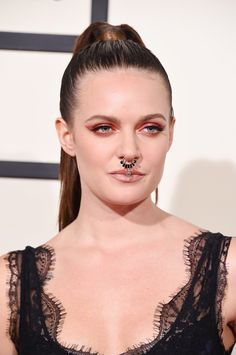 a woman with piercings on her nose at an event