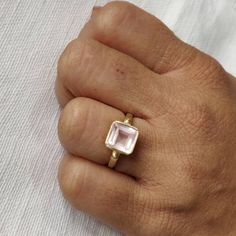 **KINDLY CHECK OUT THE VIDEO OF THE ITEM FOR A CLEARER VIEW**Details of the ring Gem: Rose Quartz Gem size & shape: 8 mm & octagon Center Gem weight: 2.60 carat Finish: matte Gold purity: 14K (58.33% approx.) Gold weight: 2.33 grams total weight of ring: 2.85 grams Fine faceted Rose Quartz gemstone ring set in solid 14K yellow gold in matte finish. The Gold purity is guaranteed and it comes with authentic 14 kt gold hallmark. Since these Rings are handmade, Size Customization is availabl Rose Colored Fine Jewelry Ring As A Gift, Morganite Bezel Setting Jewelry For Gift, Morganite Gemstone Ring For Gift, Modern Gift Rings With Rose Cut Diamonds, Rose Gold Emerald Cut Gemstone Birthstone Ring, Rose Gold Emerald Cut Birthstone Ring, Pink Gold Gemstone Rings For Gifts, Morganite Rose Gold Rings For Gifts, Rose Gold Morganite Rings Perfect For Gifts