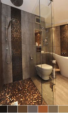 a bathroom with a tub, toilet and shower in it's center wall that has coins all over the floor