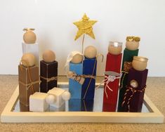 a group of small wooden figurines sitting on top of a tray