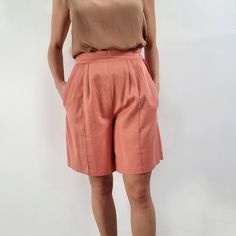 "Beautiful, smart vintage ladies shorts in peach pink. It has a fitted waist with side zip fastening, neat pleats, stitched crease line and side pockets. Perfect for looking smart in the city or worn casualy with a T-shirt. Made by Bhs in Britain. 65% polyester, 35% cotton. Labelled as size 14UK, to fit 97cm/ 38\" hips. Measurements when laid flat are: Waistband: 37cm Hips: 58cm Inner seam: 20cm Outer seam/length: 53cm Excellent condition. B." Workwear Bottoms With Pleated Waist And Short Length, Pleated Waist Short Bottoms For Workwear, Pleated Waist Short Workwear Bottoms, Fitted Pleated Waist Shorts For Work, Fitted Shorts With Pleated Waist, Casual Workwear Bottoms With Box Pleat, Spring Shorts With Pleated Waist, Pleated Waist Shorts For Spring, Spring Pleated Waist Shorts