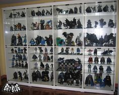 a display case filled with lots of batman action figures and figurines on shelves