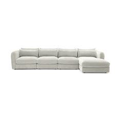 a white sectional couch sitting on top of a white floor