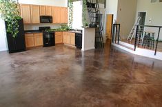 an empty kitchen and living room are shown in this house's open floor plan