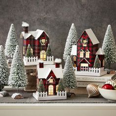 christmas decorations are displayed in front of small houses